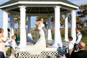 bride and groom kissing in gazebo