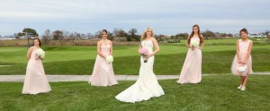 bride and bridesmaids standing on golf green