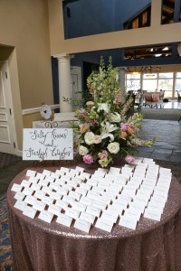 wedding entrance table with table placement cards and flowers